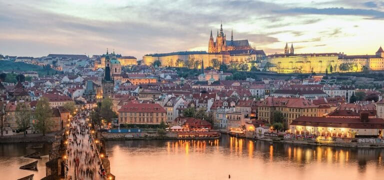 Prague Travel Guide brown concrete building near body of water during daytime