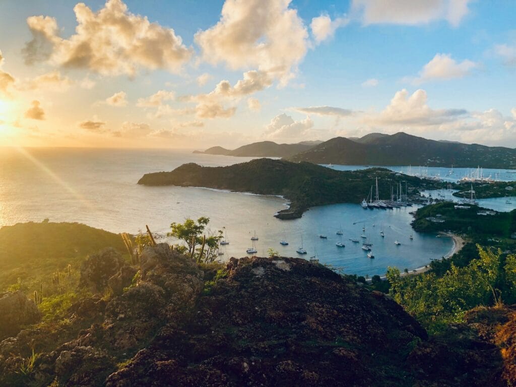 Antigua and Barbuda Travel Guide green grass field near body of water during daytime