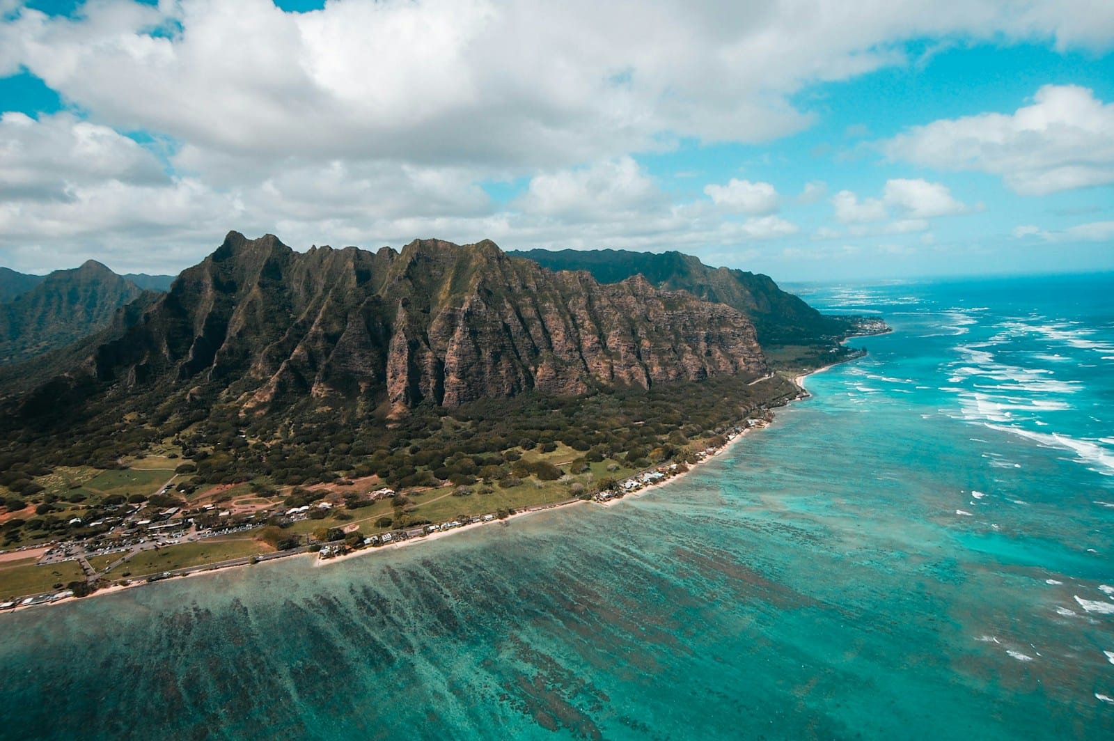 oahu travel guide island surround by green sea under cloudy sky