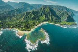 Hawaii Island Tours aerial view of green and brown mountains and lake