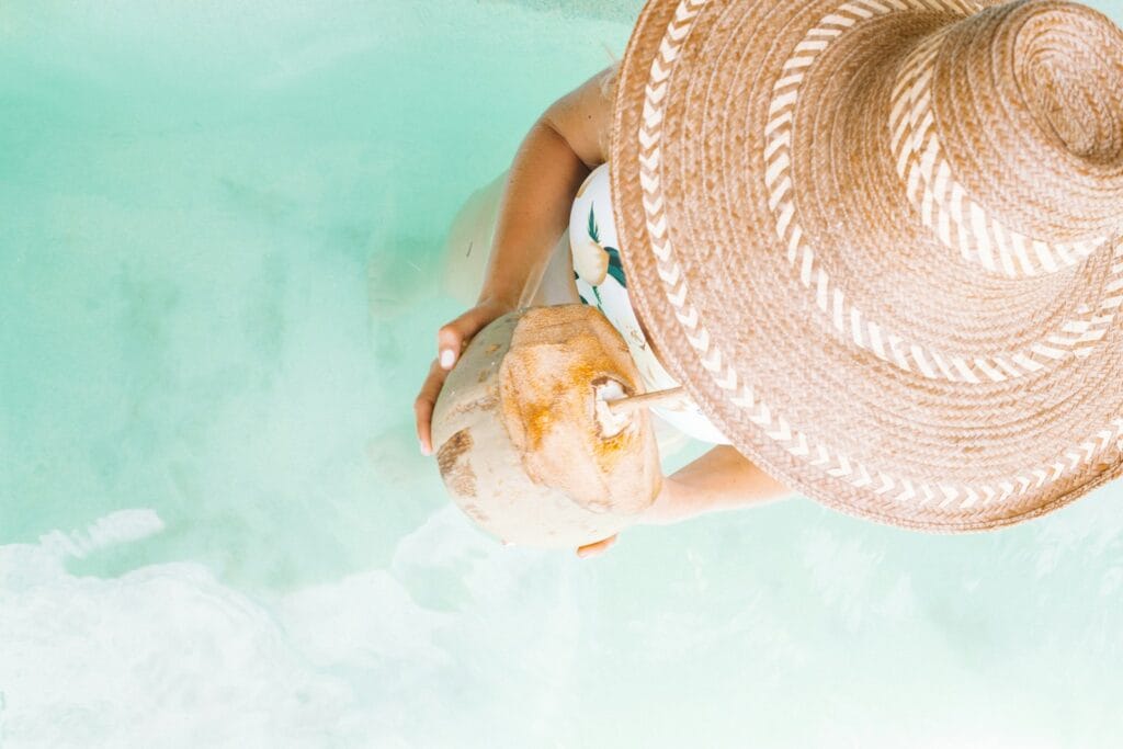 Caribbean Tours contact us person holding coconut