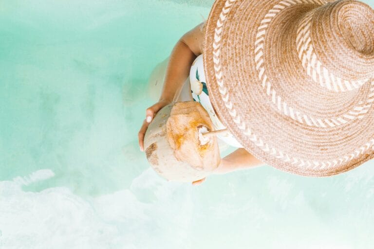 Caribbean Tours contact us person holding coconut