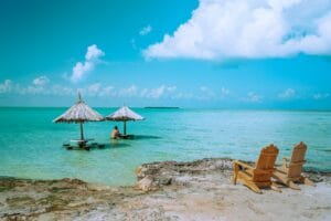 Belize tours brown wooden lounge chairs on beach during daytime