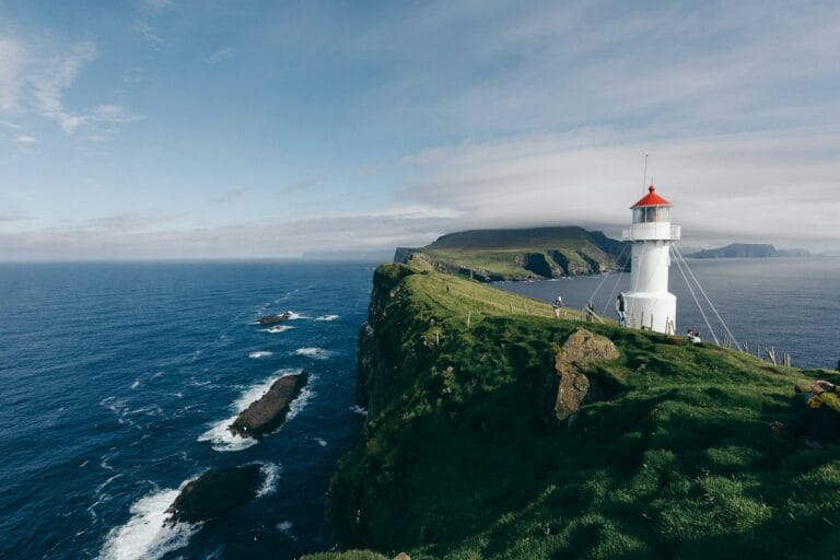 Faroe Islands Travel Guide lighthouse near body of water