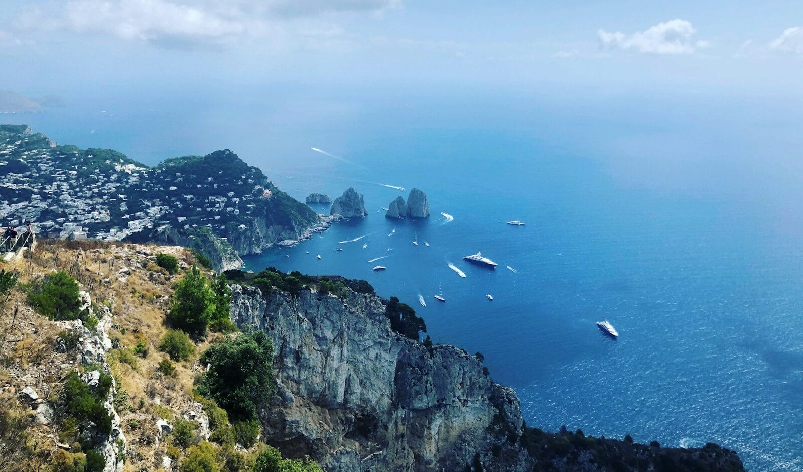 Capri Tours, green and brown mountain beside body of water under white clouds and blue sky during daytime