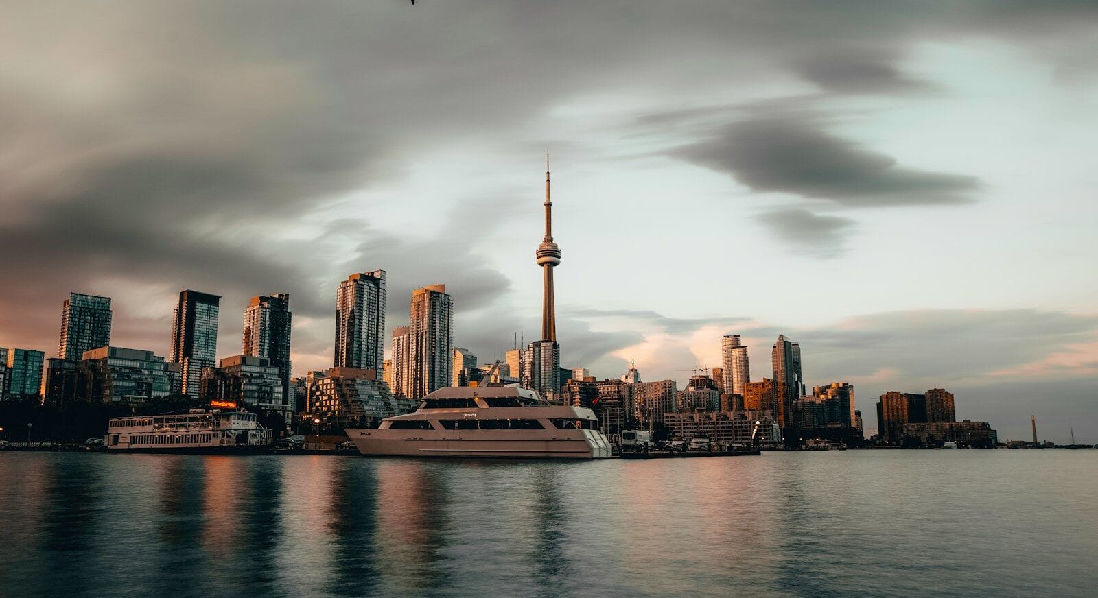 Canada Travel Guide white yacht near high-rise buildings