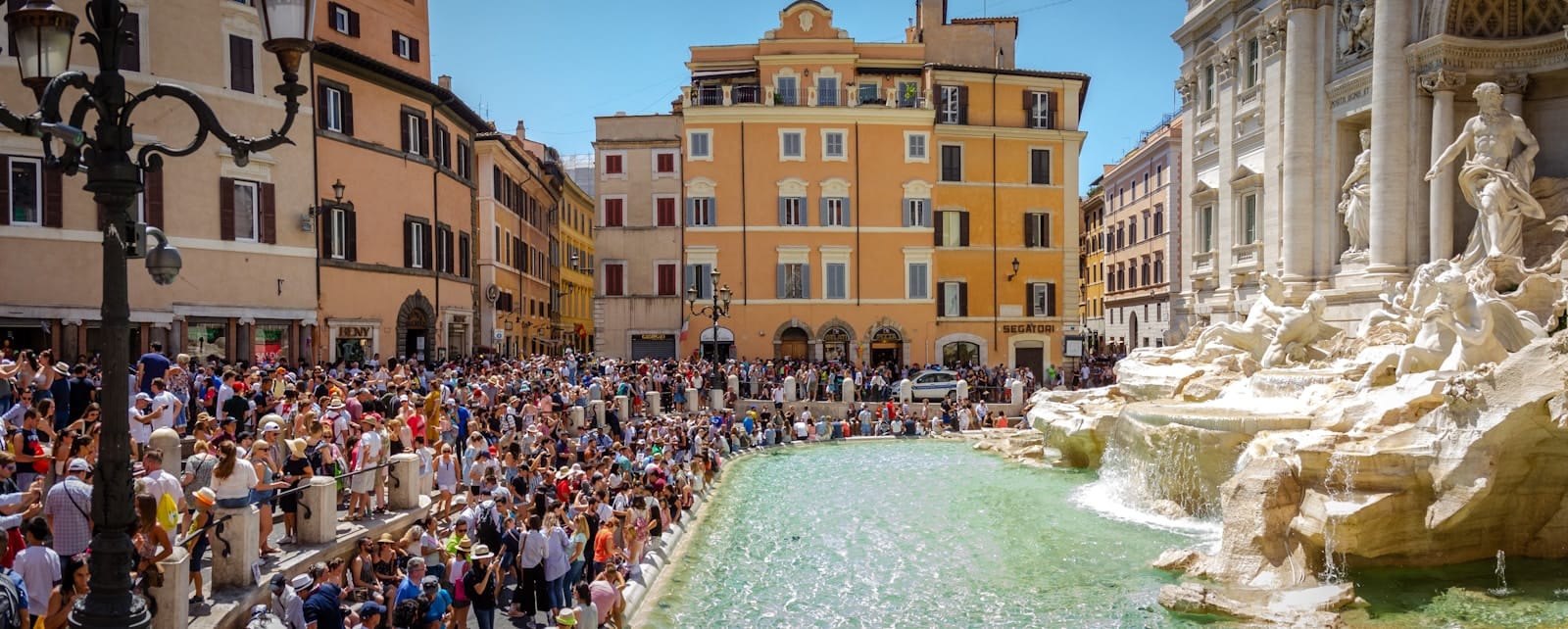 top attractions crowd of people gathered in front of Trevi Fountain