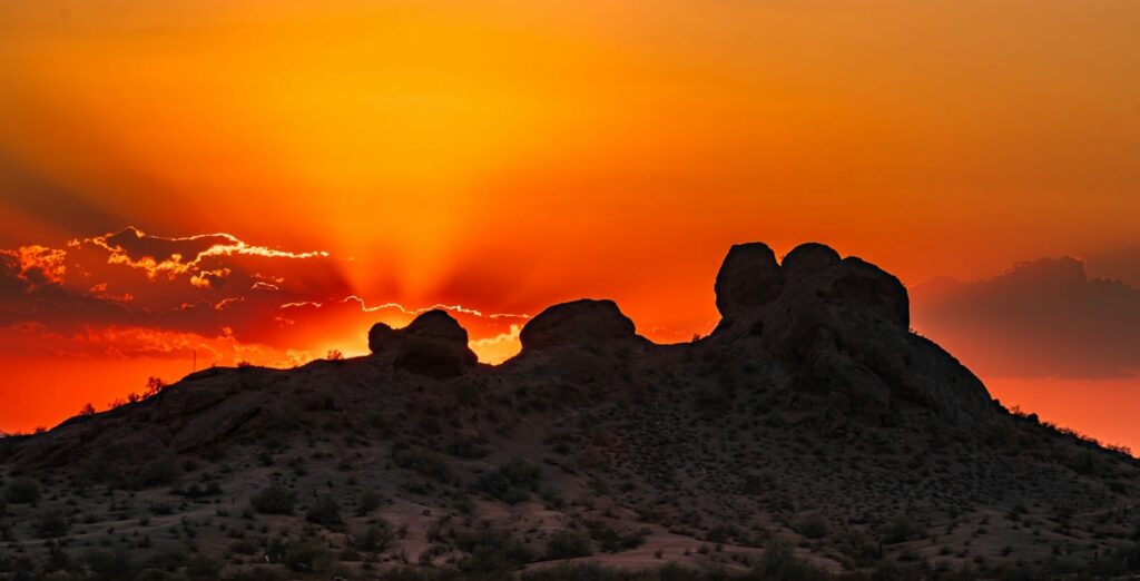 phoenix travel guide The sun is setting over the mountains in the desert