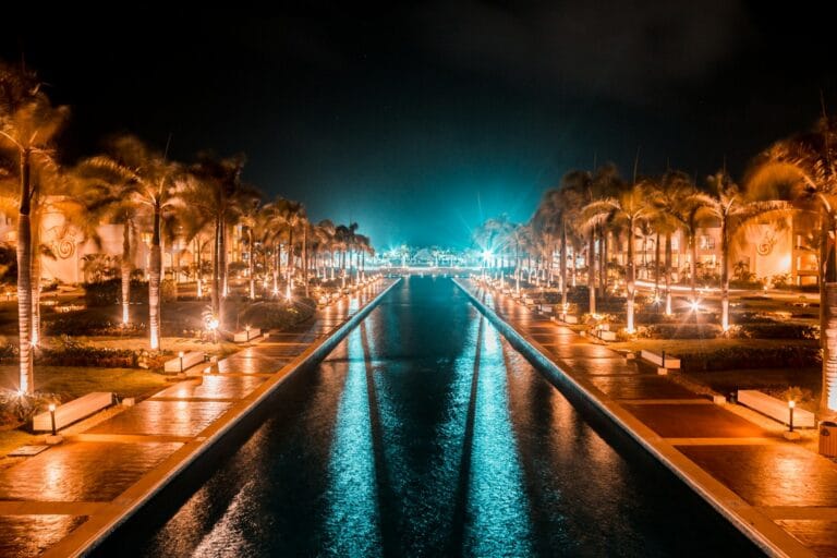 Punta Cana Travel Guide a view of a waterway at night with palm trees