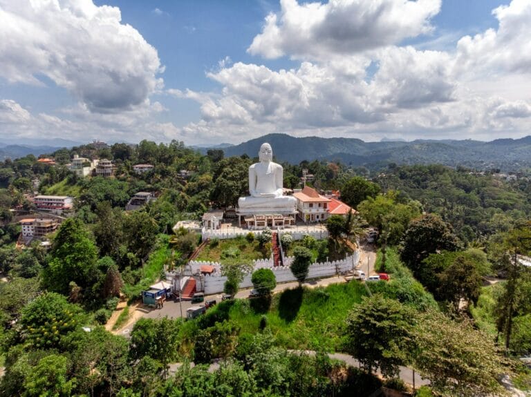 Sri Lanka Travel Guide Gautama Buddha statue under white clouds