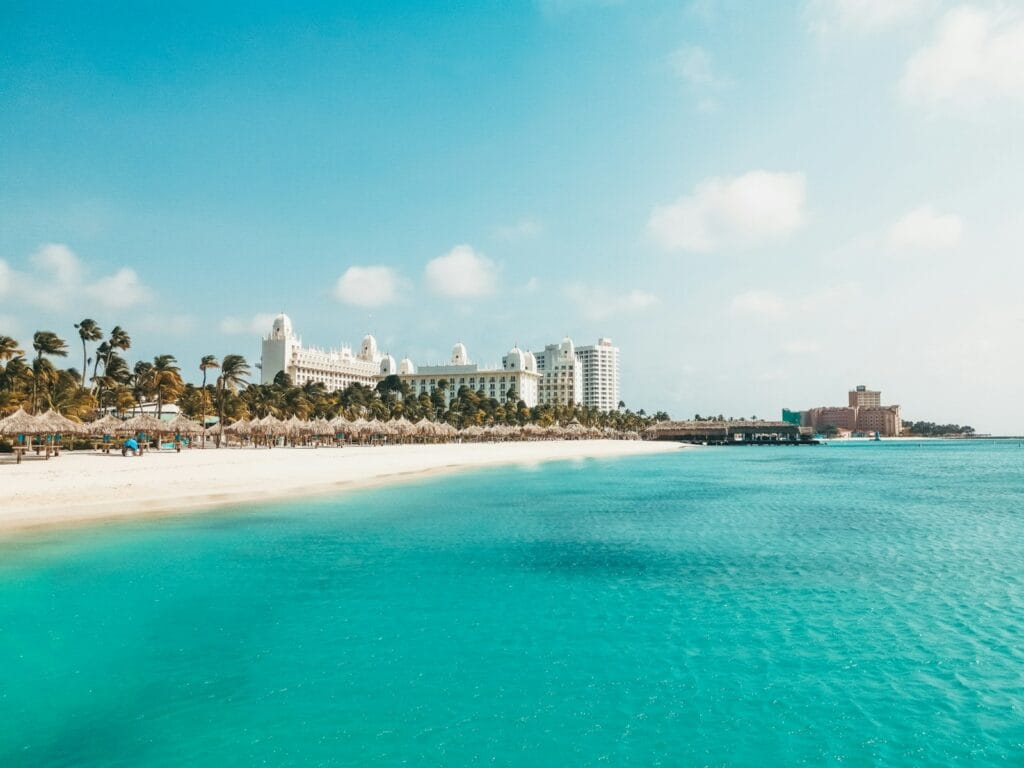 Aruba Travel Guide, a view of a beach with a hotel in the background