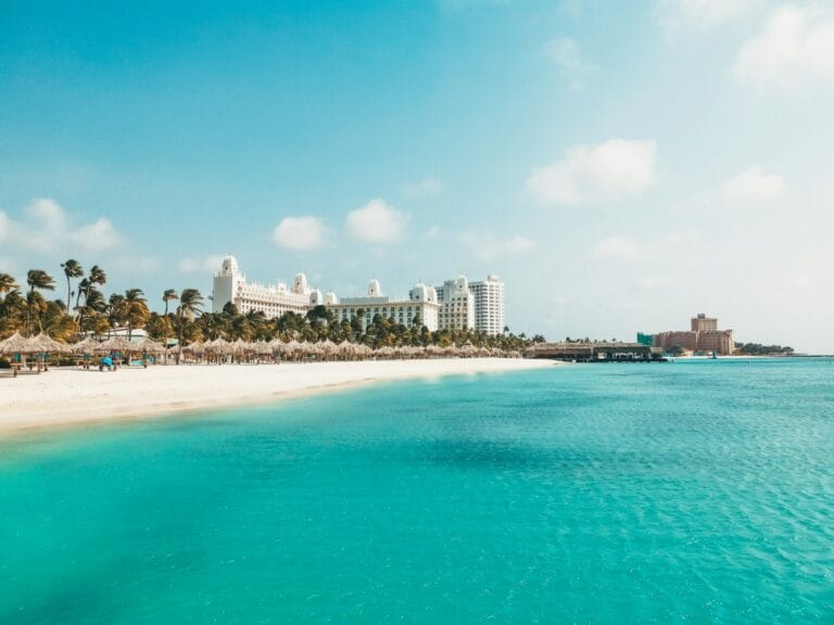 Aruba Travel Guide, a view of a beach with a hotel in the background