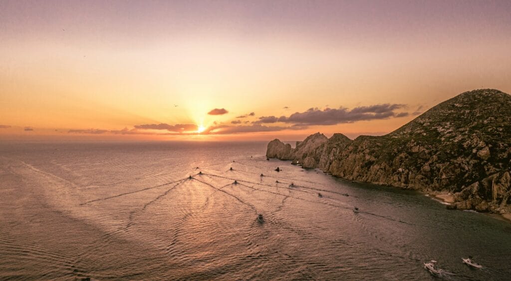 Arch of Cabo San Lucas – Iconic Ocean Landmark in Baja white rock formation on blue sea during daytime, a snowy beach with a sunset