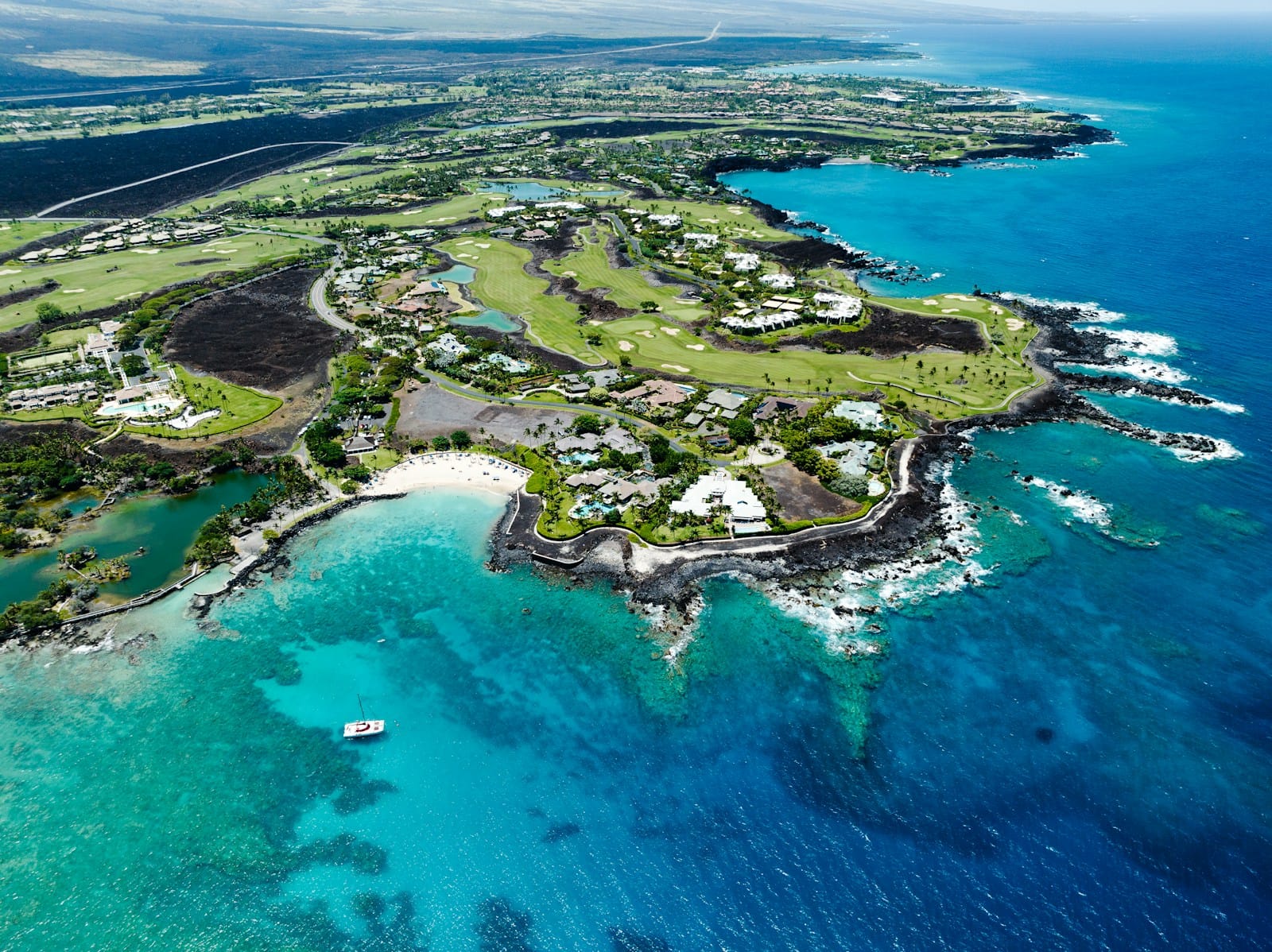 Big Island Tours an aerial view of a golf course in the ocean