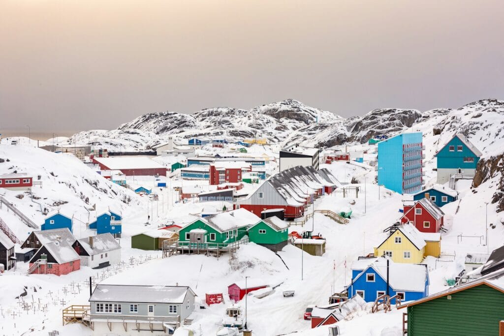 greenland travel guide town on hill covered with snow
