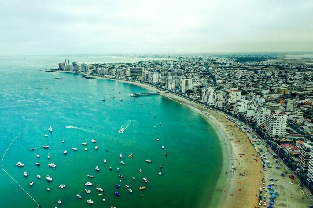 ecuador travel guide aerial view of boats on sea near city buildings during daytime