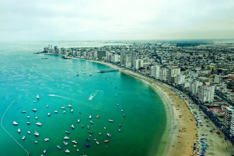 ecuador travel guide aerial view of boats on sea near city buildings during daytime