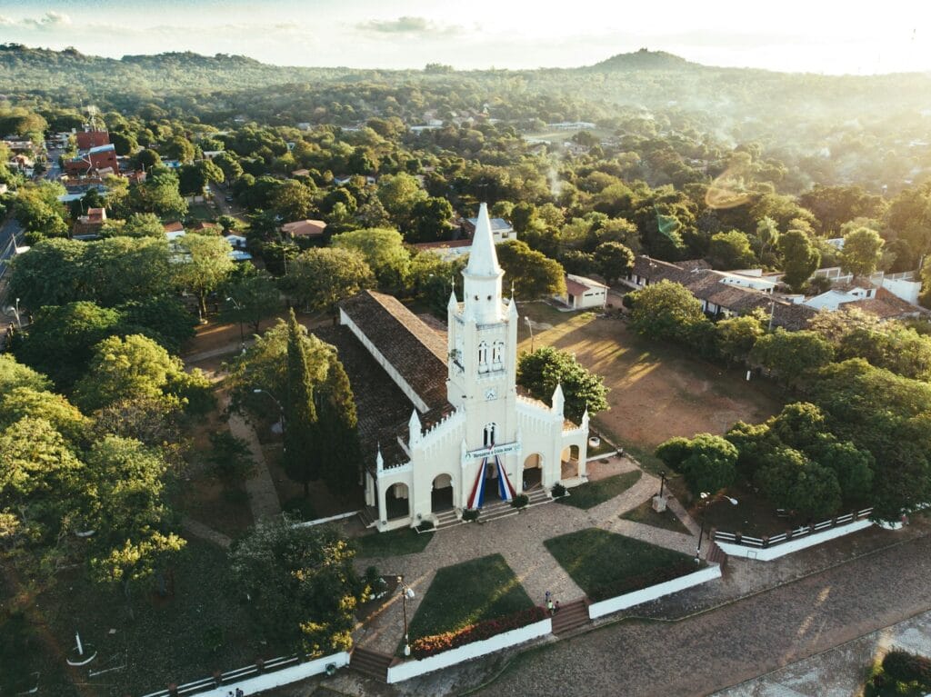 Aregua, Asunción, Paraguay
white and black church surrounded by green trees during daytime