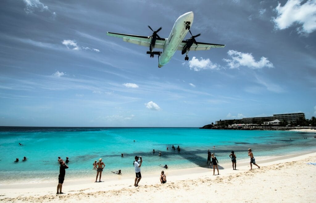 St Martin Tours, plane flying over seashore during daytime