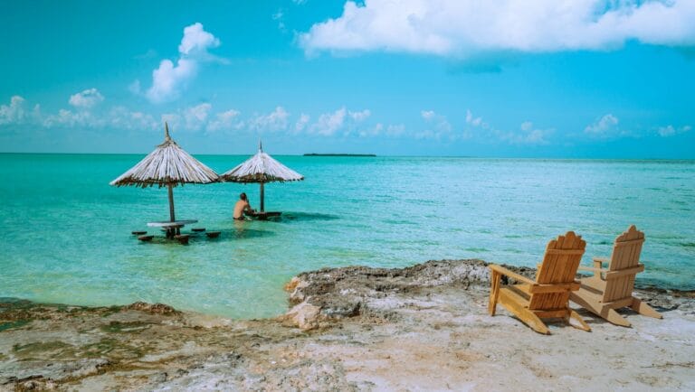 Belize Travel Guide brown wooden lounge chairs on beach during daytime