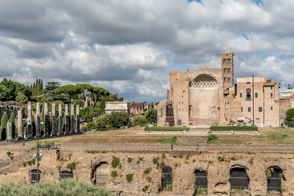 Palatine Hill a stone building with a stone wall with Roman Forum in the background