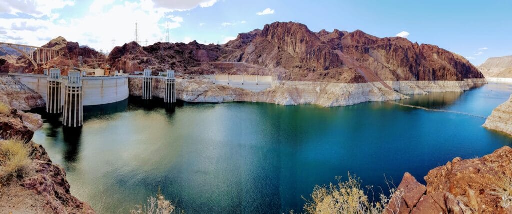 Hoover Dam Tours: Epic Day Trips & Scenic Experiences Hoover Dam Tours brown wooden dock on river near brown mountain under blue sky during daytime