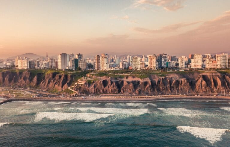 peru travel guide road near body of water and buildings at daytime