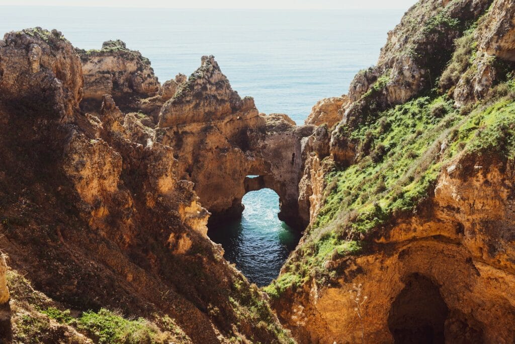 Algarve, Portugal brown rock formation near body of water during daytime