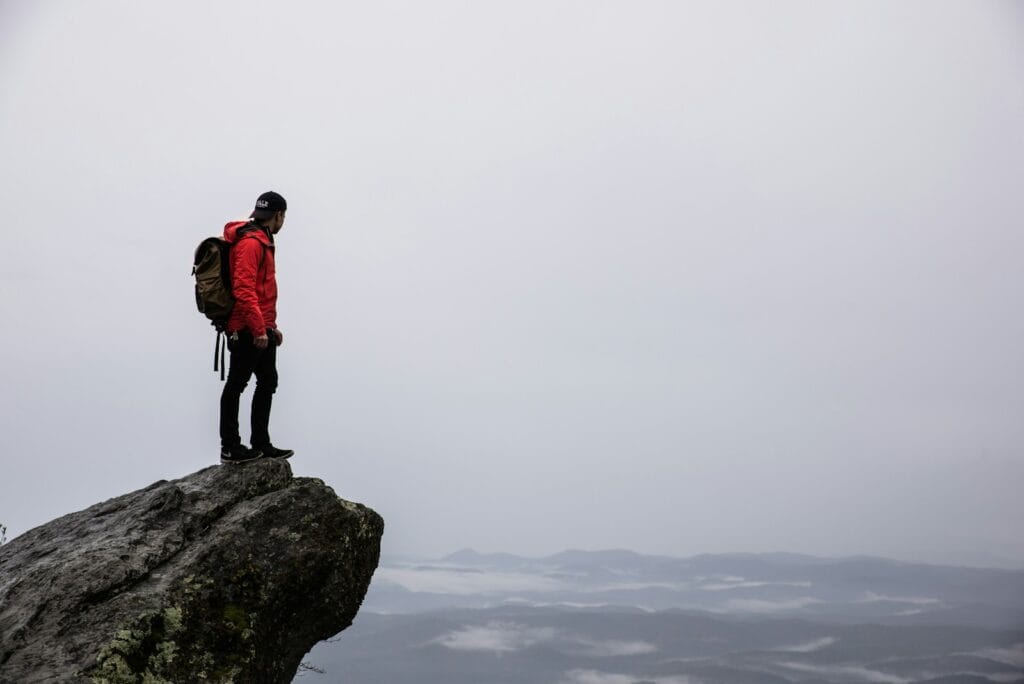 Travel Mindset person standing on gray rock