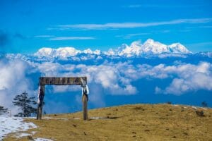 nepal travel guide brown wooden bench on brown field under blue and white cloudy sky during daytime