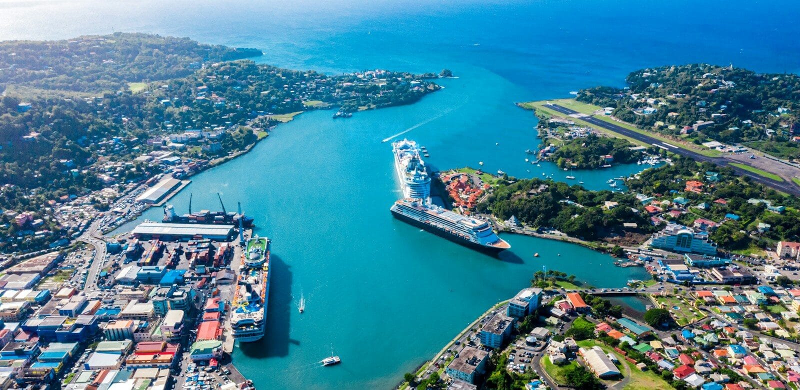 Explore Caribbean Islands Travel Guide aerial view of city buildings near body of water during daytime