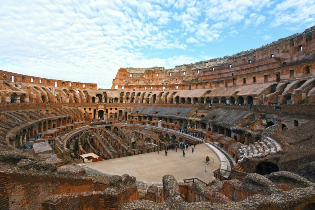 colosseum people walking on brown concrete bridge during daytime