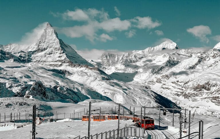 switzerland tours snow covered mountain under blue sky during daytime