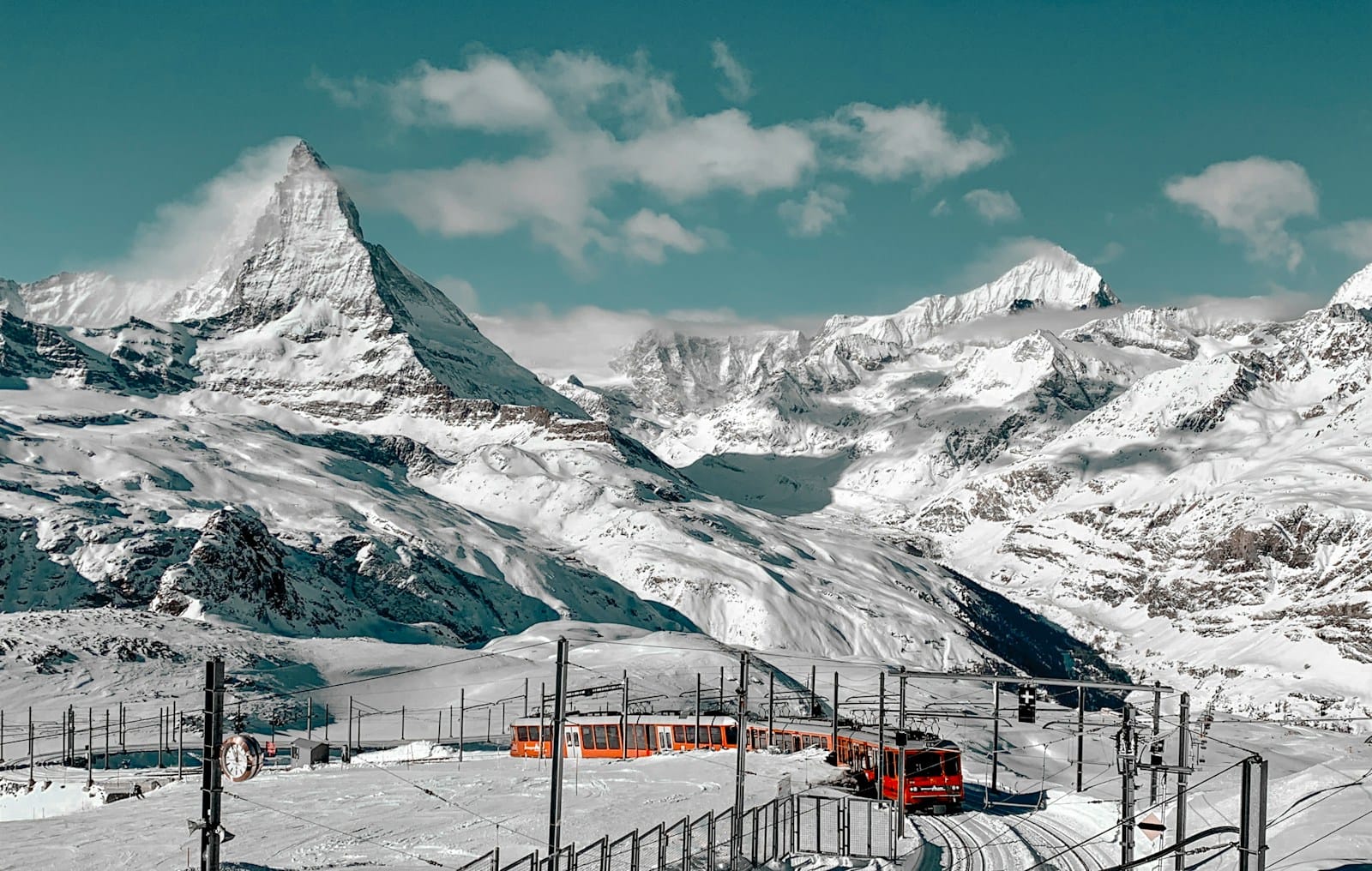 switzerland tours snow covered mountain under blue sky during daytime