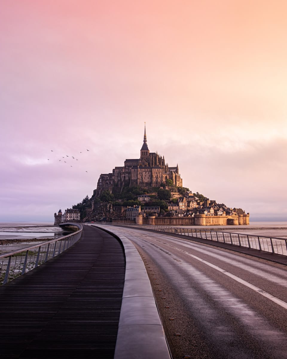 France, brown concrete building near body of water during daytime