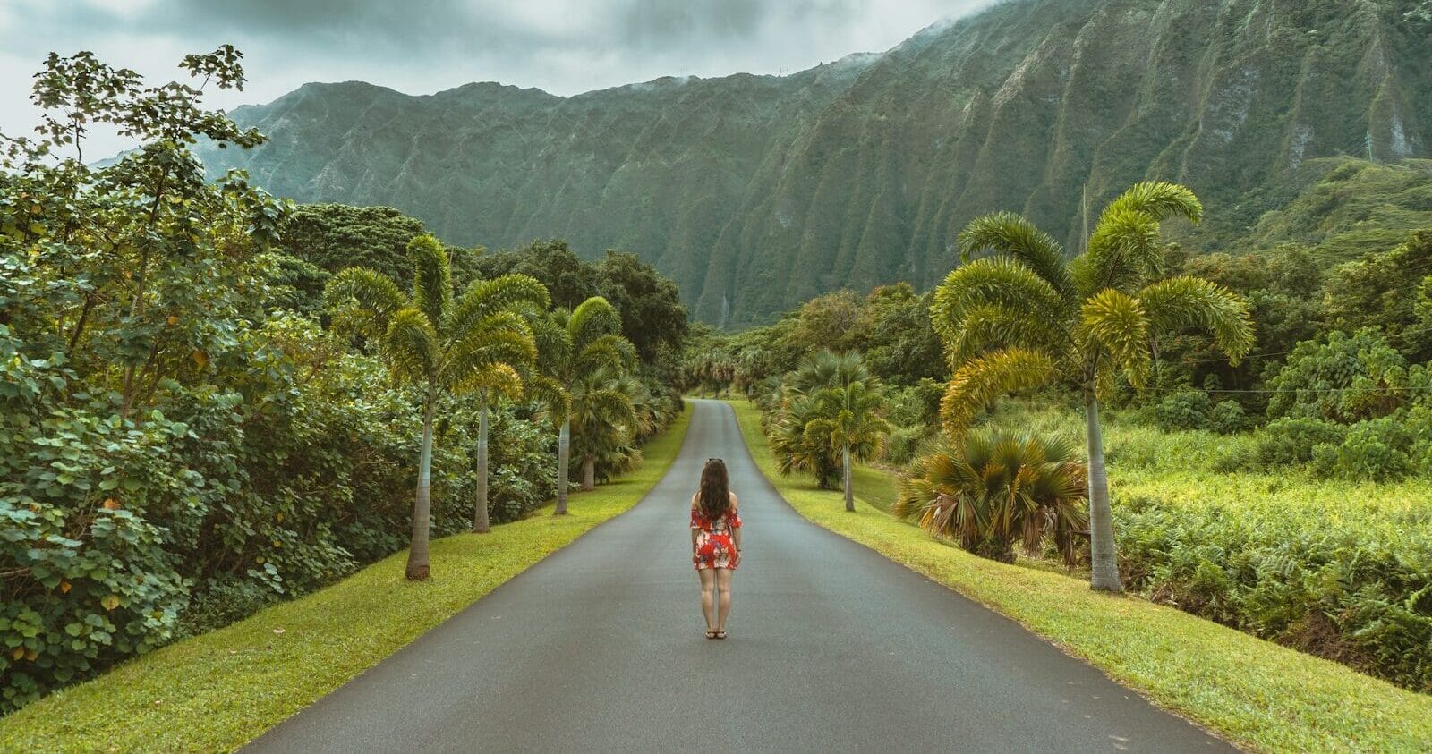 hawaii airlines woman walking in black concrete road in front of mountain
