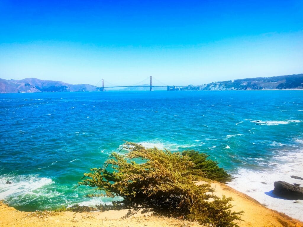San Francisco Travel Guide Golden Gate bridge seen across the bay under clear blue sky