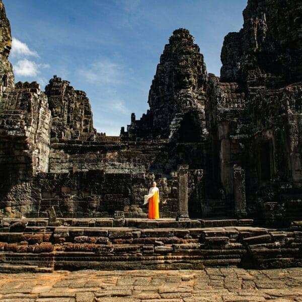 Siem Reap Travel Guide A person standing in front of a stone building