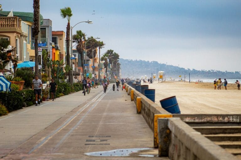 San Diego Tours people walking on sidewalk near body of water during daytime