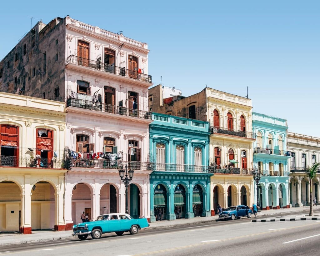 Cuba Travel Guide Destination Map Highlights: Cuba’s Regional Breakdown two cars parked outside building