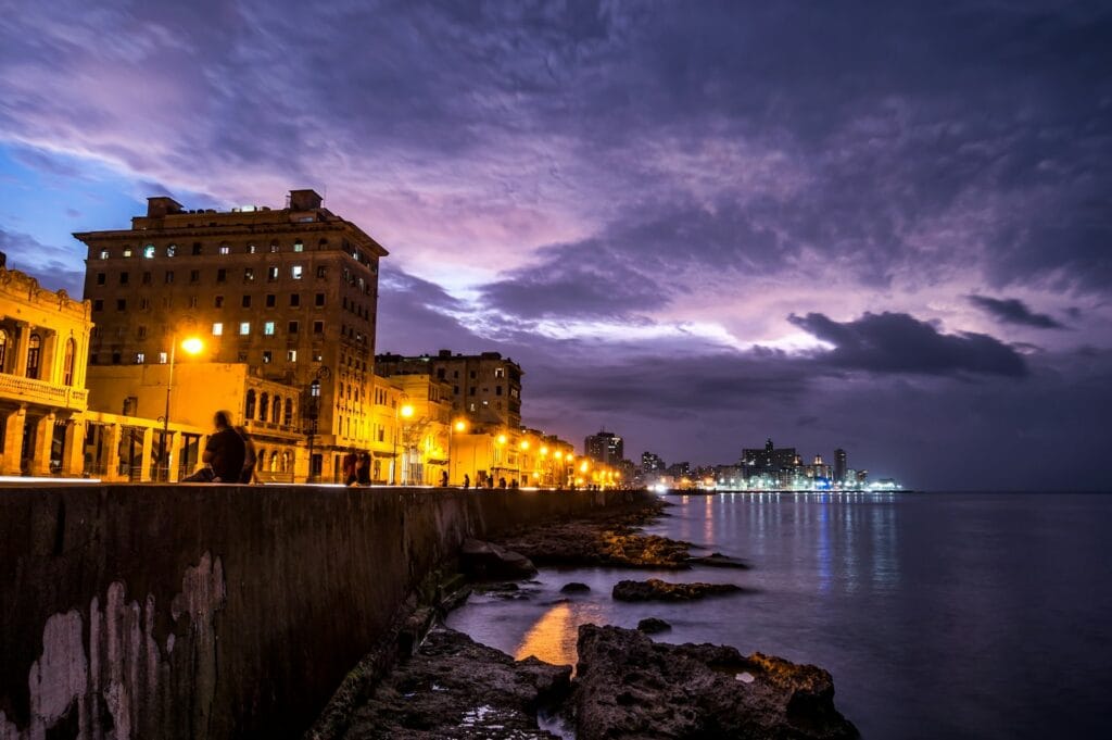 Cuba Travel Guide Most Photogenic Views & Instagram Spots lighted post lamps near sea during night