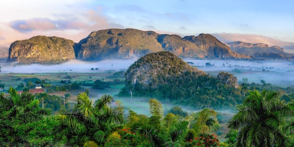 Cuba Travel Guide aerial photography of mountains and near trees during daytime