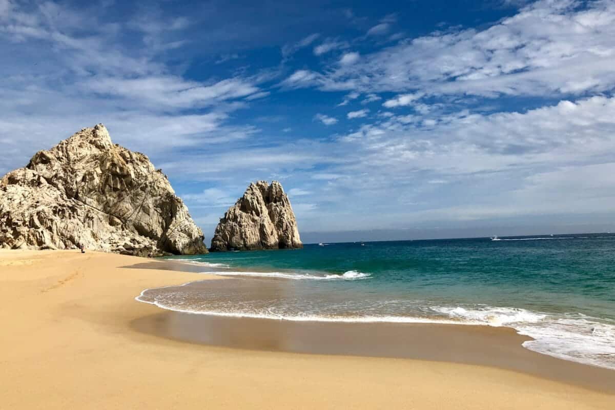 Los Cabos Tours brown rock formation on sea shore under blue sky and white clouds during daytime