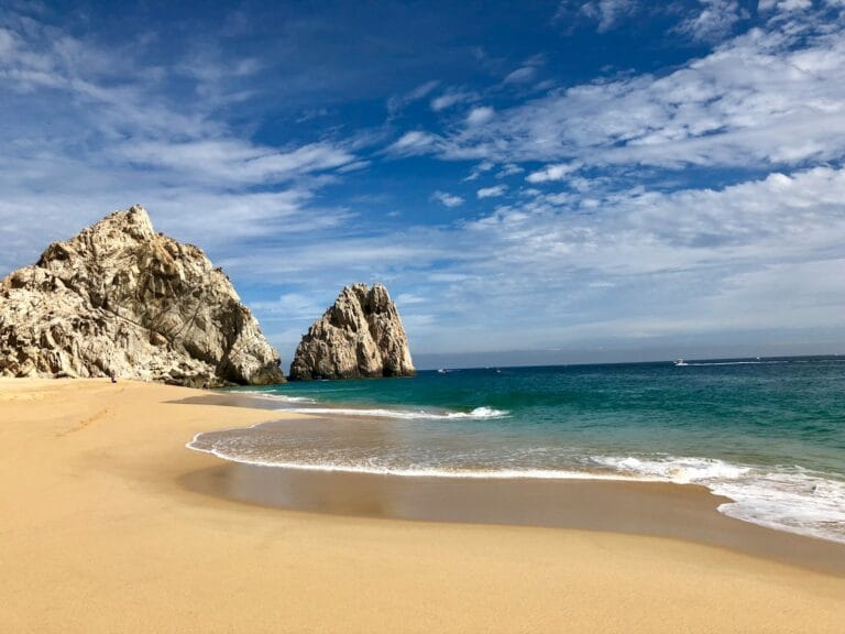 Los Cabos Tours brown rock formation on sea shore under blue sky and white clouds during daytime