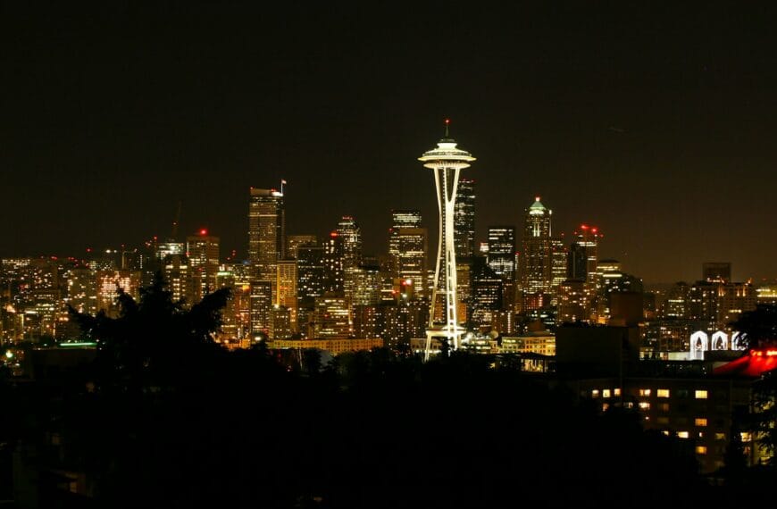 Seattle Travel Guide a view of a city at night with the space needle in the background