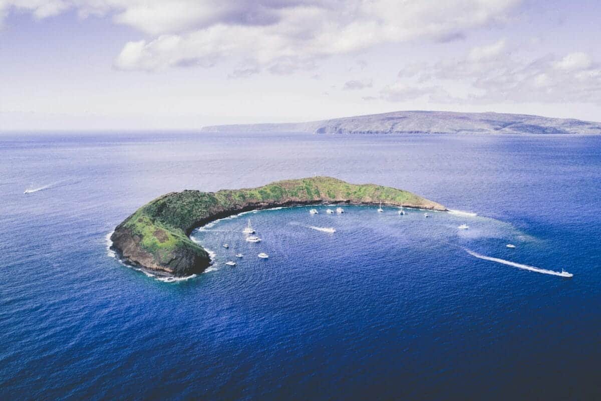 Molokini Crater body of water under white cloudy sky during daytime photo