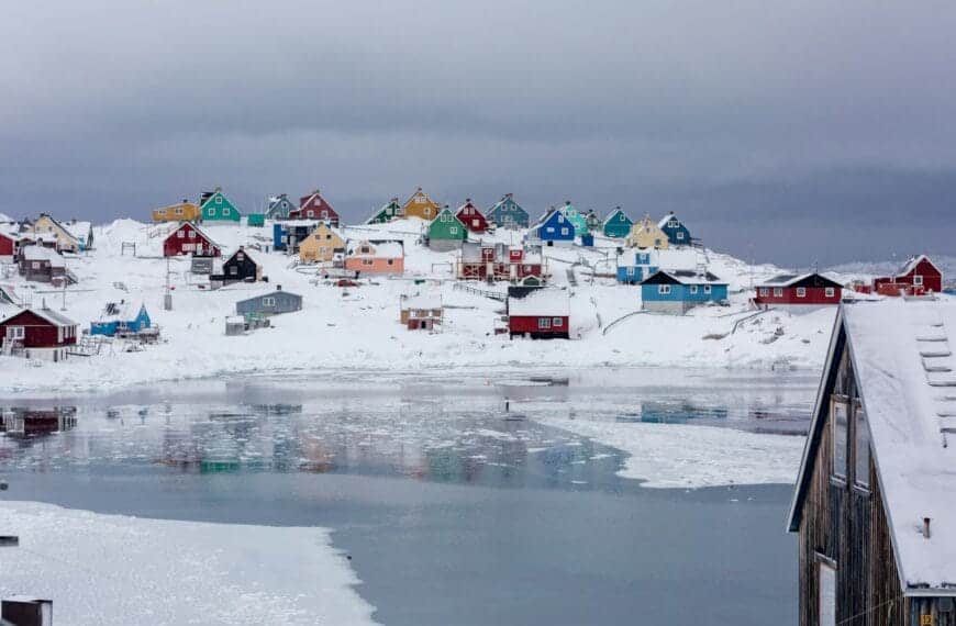 Greenland Tours view photography of assorted-color houses near pond during daytime