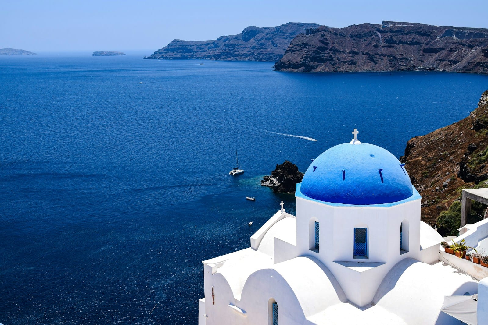 Santorini Tours a view of a body of water from a hill