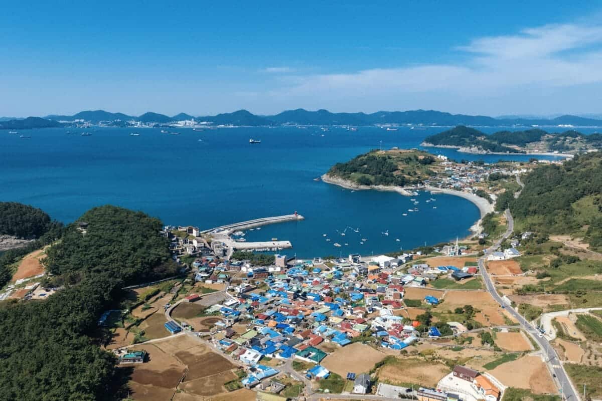 South Korea Tours a large body of water surrounded by a lush green hillside