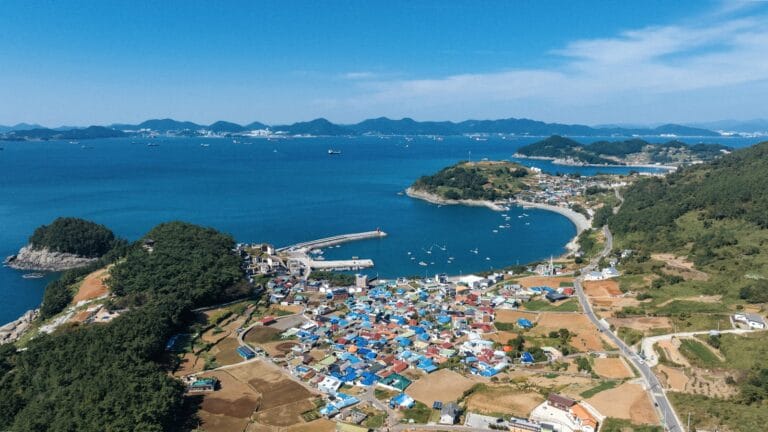 South Korea Tours a large body of water surrounded by a lush green hillside